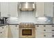 Close-up of the kitchen area with stainless steel appliances and classic subway tile backsplash at 16525 Tulloch Rd, Charlotte, NC 28278