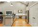 Well-lit kitchen boasts granite counters, stainless appliances, and ample cabinet space for cooking at 16525 Tulloch Rd, Charlotte, NC 28278