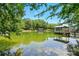 Picturesque lake view featuring a charming gazebo, lush greenery, and serene water reflecting the sky at 16525 Tulloch Rd, Charlotte, NC 28278