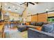 Open living space with a large sectional, island seating, and industrial barn door accent at 16525 Tulloch Rd, Charlotte, NC 28278
