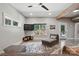 Cozy living room with natural light, stylish furniture, and access to screened porch at 16525 Tulloch Rd, Charlotte, NC 28278