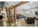 Open living space with wooden stairs, brick, and comfortable seating with natural light at 16525 Tulloch Rd, Charlotte, NC 28278