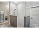 Contemporary shower with white subway tile, gray accent wall, and glass enclosure at 16525 Tulloch Rd, Charlotte, NC 28278