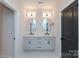 Bright bathroom featuring double vanity, arched mirrors and modern fixtures at 1724 Dallas Ave, Charlotte, NC 28205