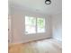 Bedroom with light wood floors and large windows at 1724 Dallas Ave, Charlotte, NC 28205