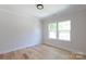 Bedroom with light wood floors and large windows at 1724 Dallas Ave, Charlotte, NC 28205