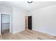 Bright bedroom features hardwood floors, closet and black door with white trim at 1724 Dallas Ave, Charlotte, NC 28205