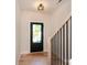 Welcoming entryway with stylish light fixture, featuring a sleek door and modern staircase railing at 1724 Dallas Ave, Charlotte, NC 28205