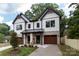 Charming two-story home with white siding, black trim, and wood accents; two-car garage at 1724 Dallas Ave, Charlotte, NC 28205