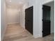 Hallway with light wood flooring and dark doors at 1724 Dallas Ave, Charlotte, NC 28205