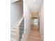 Bright hallway with hardwood floors leads to stairs, enhancing the home's modern design at 1724 Dallas Ave, Charlotte, NC 28205