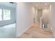 Light wood floors in this bright hallway with white walls at 1724 Dallas Ave, Charlotte, NC 28205