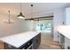 Modern kitchen with an island, white cabinets and stainless steel appliances and an open floor plan at 1724 Dallas Ave, Charlotte, NC 28205