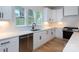 Well-lit kitchen featuring stainless steel appliances, white cabinets, and light countertops with a stainless steel dishwasher at 1724 Dallas Ave, Charlotte, NC 28205