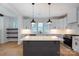 Modern kitchen with a large island, white quartz countertops, stainless steel appliances, and plenty of storage space at 1724 Dallas Ave, Charlotte, NC 28205