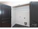 Laundry room with dark gray door and black tile floor at 1724 Dallas Ave, Charlotte, NC 28205