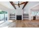Bright living room with wooden beams, fireplace, and built-in shelves, offering a cozy and stylish space at 1724 Dallas Ave, Charlotte, NC 28205