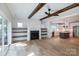 Open-concept living space with fireplace, built-ins, and adjacent kitchen, perfect for modern living and entertaining at 1724 Dallas Ave, Charlotte, NC 28205