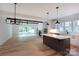 Open-concept floorplan with hardwood floors and a seamless transition from the modern kitchen to a light-filled living area at 1724 Dallas Ave, Charlotte, NC 28205