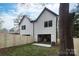 This cozy backyard features a well-maintained lawn, newly installed wooden fence and modern house design at 1728 Dallas Ave, Charlotte, NC 28205