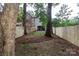 A partially-shaded backyard features a newly-installed wooden fence, and mature trees at 1728 Dallas Ave, Charlotte, NC 28205