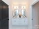 Bathroom featuring double vanity with two mirrors and lights at 1728 Dallas Ave, Charlotte, NC 28205