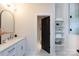 Bright bathroom with white cabinets, quartz counters, modern fixtures, and a decorative arched mirror at 1728 Dallas Ave, Charlotte, NC 28205