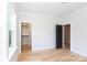 Bedroom features wood floor and black door and walk in closet creating a modern feel at 1728 Dallas Ave, Charlotte, NC 28205
