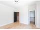 Bedroom features wood floor and black door and walk in closet creating a modern feel at 1728 Dallas Ave, Charlotte, NC 28205