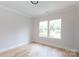 Bedroom with wood floor and two windows creating a bright space at 1728 Dallas Ave, Charlotte, NC 28205