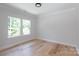 Bedroom with wood floor and two windows creating a bright space at 1728 Dallas Ave, Charlotte, NC 28205