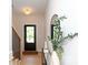 Inviting foyer with sleek mirror, modern lighting, wood floors, and a glimpse of the outdoors through the glass door at 1728 Dallas Ave, Charlotte, NC 28205