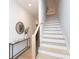 Bright hallway features hardwood floors, staircase, console table with a mirror, and modern decor at 1728 Dallas Ave, Charlotte, NC 28205