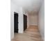 Hallway features wood floors, white walls and a black interior door at 1728 Dallas Ave, Charlotte, NC 28205
