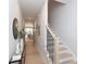 Hallway with hardwood floors, staircase, and console table leading to dining area at 1728 Dallas Ave, Charlotte, NC 28205