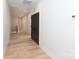 Hallway with wood floor and white walls with black doors providing a modern look at 1728 Dallas Ave, Charlotte, NC 28205
