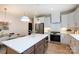 Modern kitchen with island seating, stainless steel appliances, and white cabinets with brass hardware at 1728 Dallas Ave, Charlotte, NC 28205