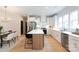 Stylish kitchen with an island with barstool seating, white cabinets, and stainless steel appliances at 1728 Dallas Ave, Charlotte, NC 28205