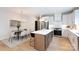 Modern kitchen with island seating, stainless steel appliances, and white cabinets with brass hardware at 1728 Dallas Ave, Charlotte, NC 28205