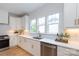 Bright kitchen showcasing white cabinets, stainless appliances, a brass faucet, and lots of counter space at 1728 Dallas Ave, Charlotte, NC 28205