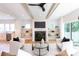 Living room featuring a fireplace, built-in shelves, and sliding doors to the outdoor space for seamless entertaining at 1728 Dallas Ave, Charlotte, NC 28205