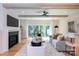 A bright living room features a modern fireplace, TV, backyard access, and cozy seating on hardwood floors at 1728 Dallas Ave, Charlotte, NC 28205