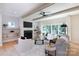 Cozy living room with fireplace, shelving, ceiling fan, and modern decor, enhanced by sliding doors to the outdoors at 1728 Dallas Ave, Charlotte, NC 28205