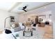 Open-concept living room with a ceiling fan, modern furniture, and hardwood floors flowing into the kitchen at 1728 Dallas Ave, Charlotte, NC 28205
