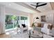 Inviting living room features beamed ceilings, fan, modern decor, and sliding doors with backyard views at 1728 Dallas Ave, Charlotte, NC 28205