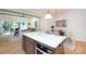 Open concept living room and kitchen area with a central island and a dining area with natural lighting at 1728 Dallas Ave, Charlotte, NC 28205