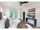 Bright primary bedroom with a ceiling fan, two windows, and hardwood floors at 1728 Dallas Ave, Charlotte, NC 28205