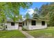 Charming home with a manicured lawn, classic windows, and inviting entry, set against a clear blue sky at 17403 Green Hill Rd, Charlotte, NC 28278