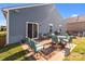Backyard patio with a table, chairs, and a grill, perfect for outdoor gatherings at 185 Willow Valley Dr, Mooresville, NC 28115