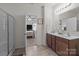 Bright bathroom with wood cabinets, shower, and easy access to the main bedroom provides a convenient and private retreat at 185 Willow Valley Dr, Mooresville, NC 28115